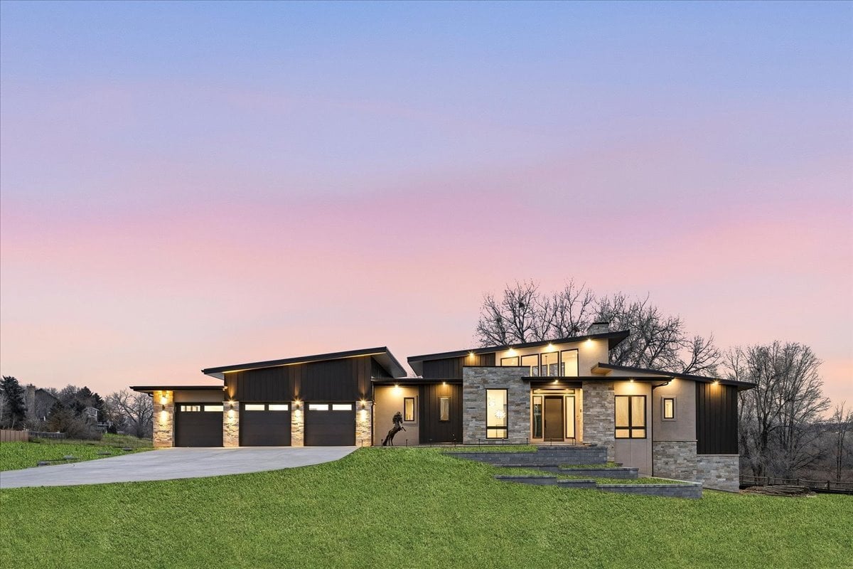 Plan 4977 exterior front twilight with lights on