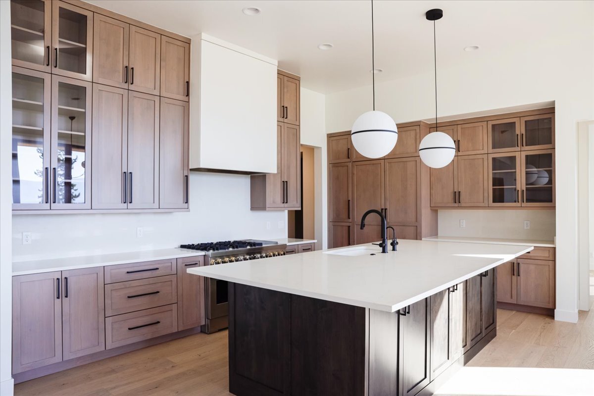 gourmet chef's kitchen with custom range hood and gas cooktop