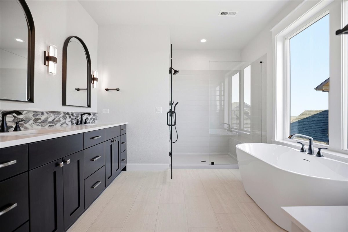 Plan #3964 - Primary bath with double vanity, large shower, and free-standing tub
