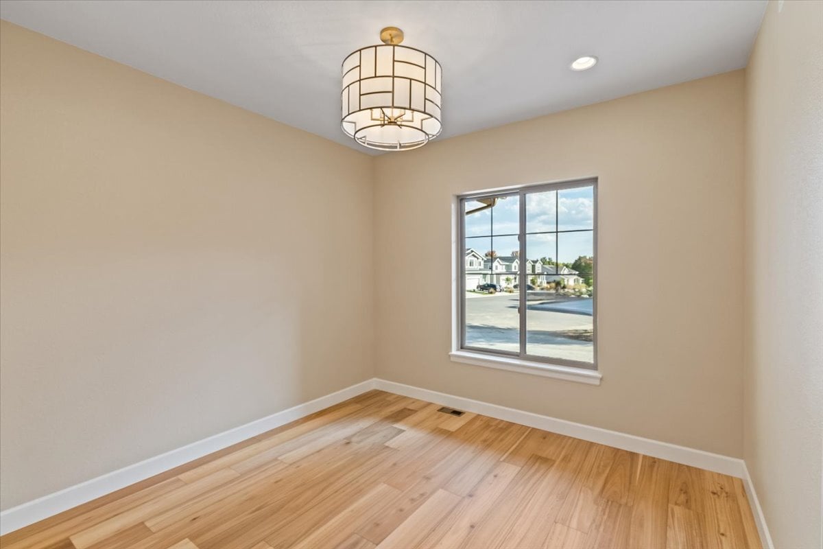 interior room with large window and stylish overhead light fixture