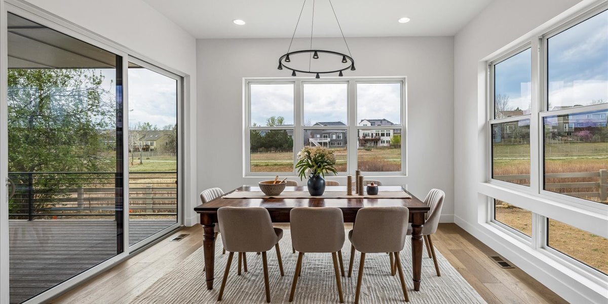 dining area surrounded by windows and patio door