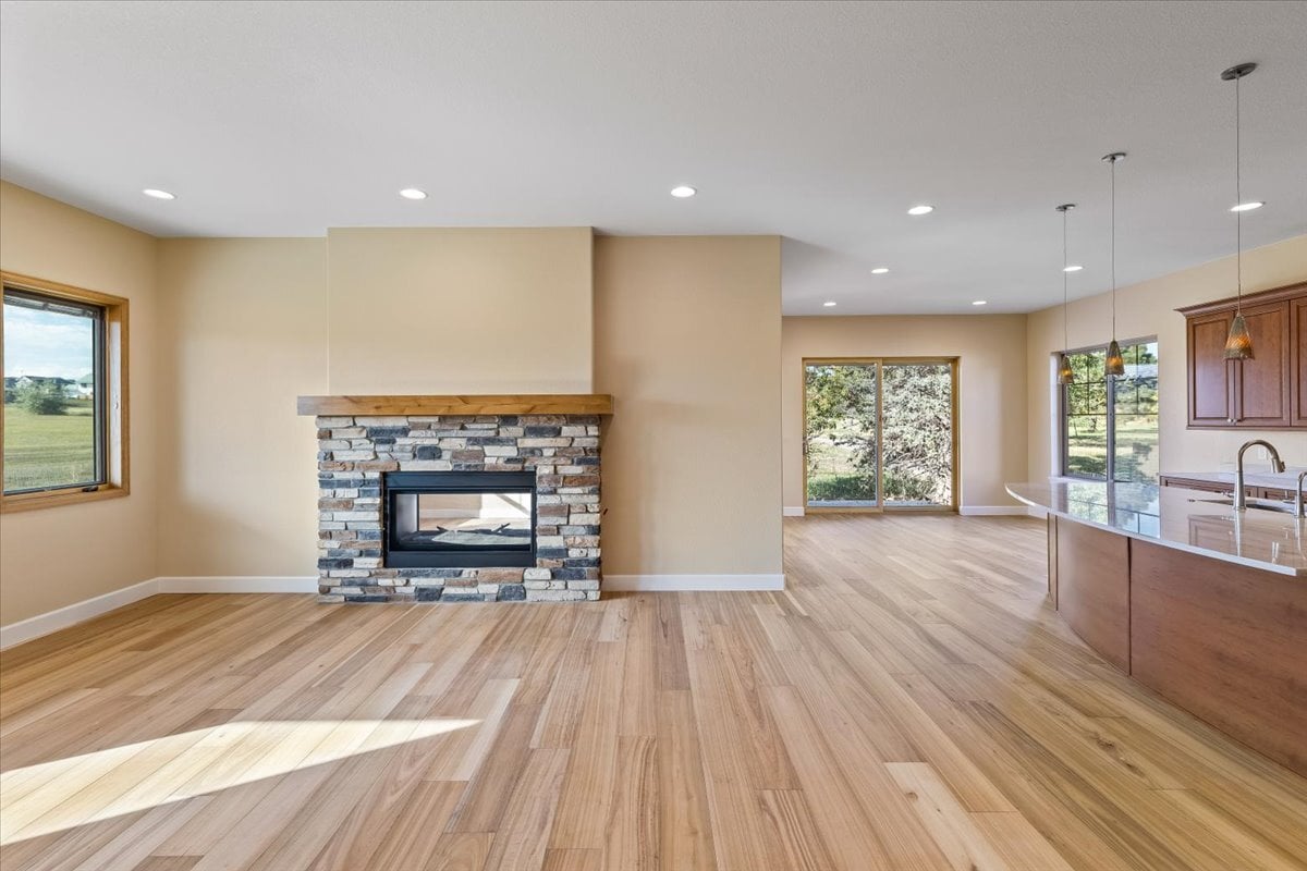 great room with hardwood flooring and fireplace