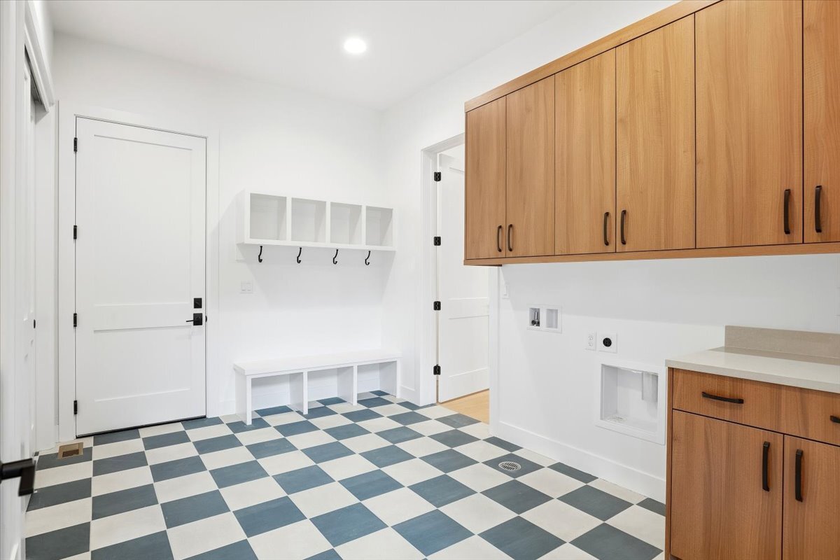 Plan 3461 laundry room with checked tile floor and built-in cubbies