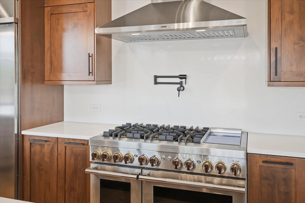 Fraser custom home - range and hood with pot-filler