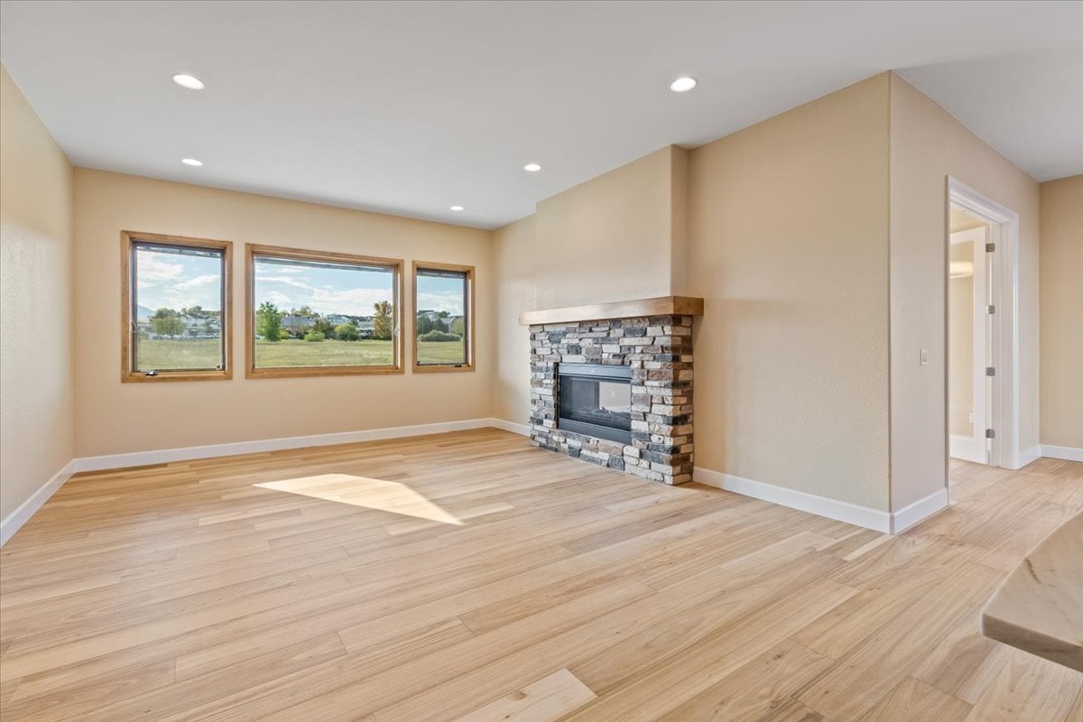 great room with fireplace and picture windows with views