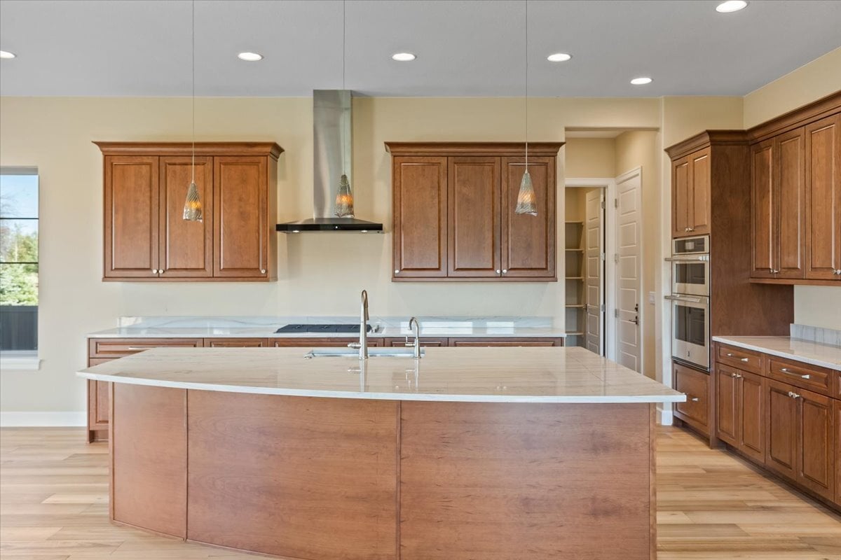 kitchen with large, wood-trimmed curved island