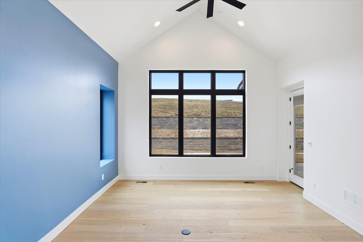 Plan 3461 primary bedroom with vaulted ceiling and accent wall