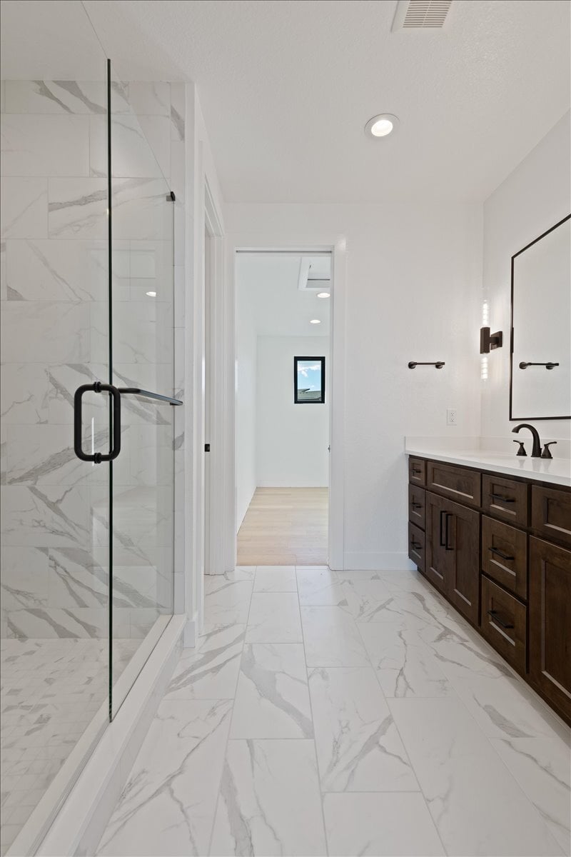 marble shower in primary suite