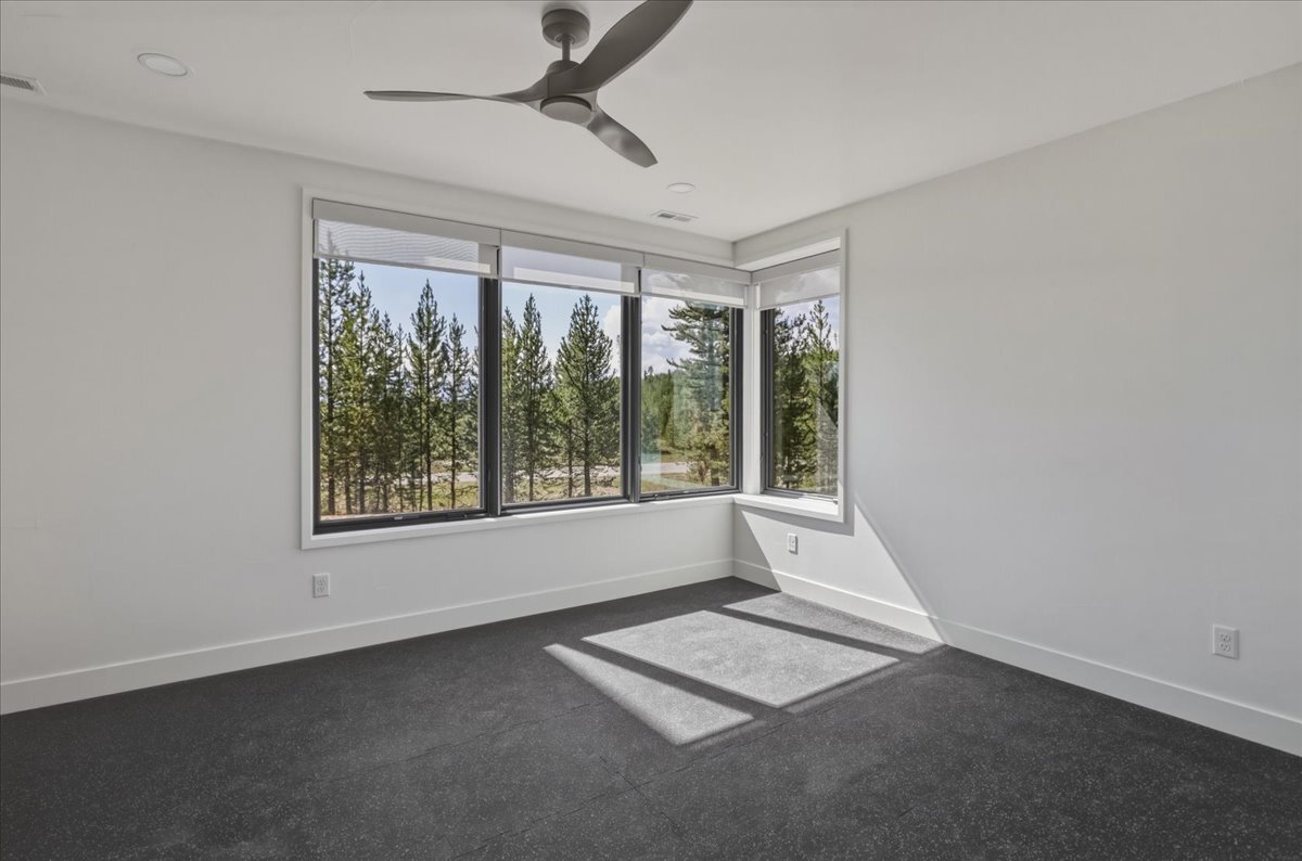 basement exercise room with rubber mat flooring and mountain views