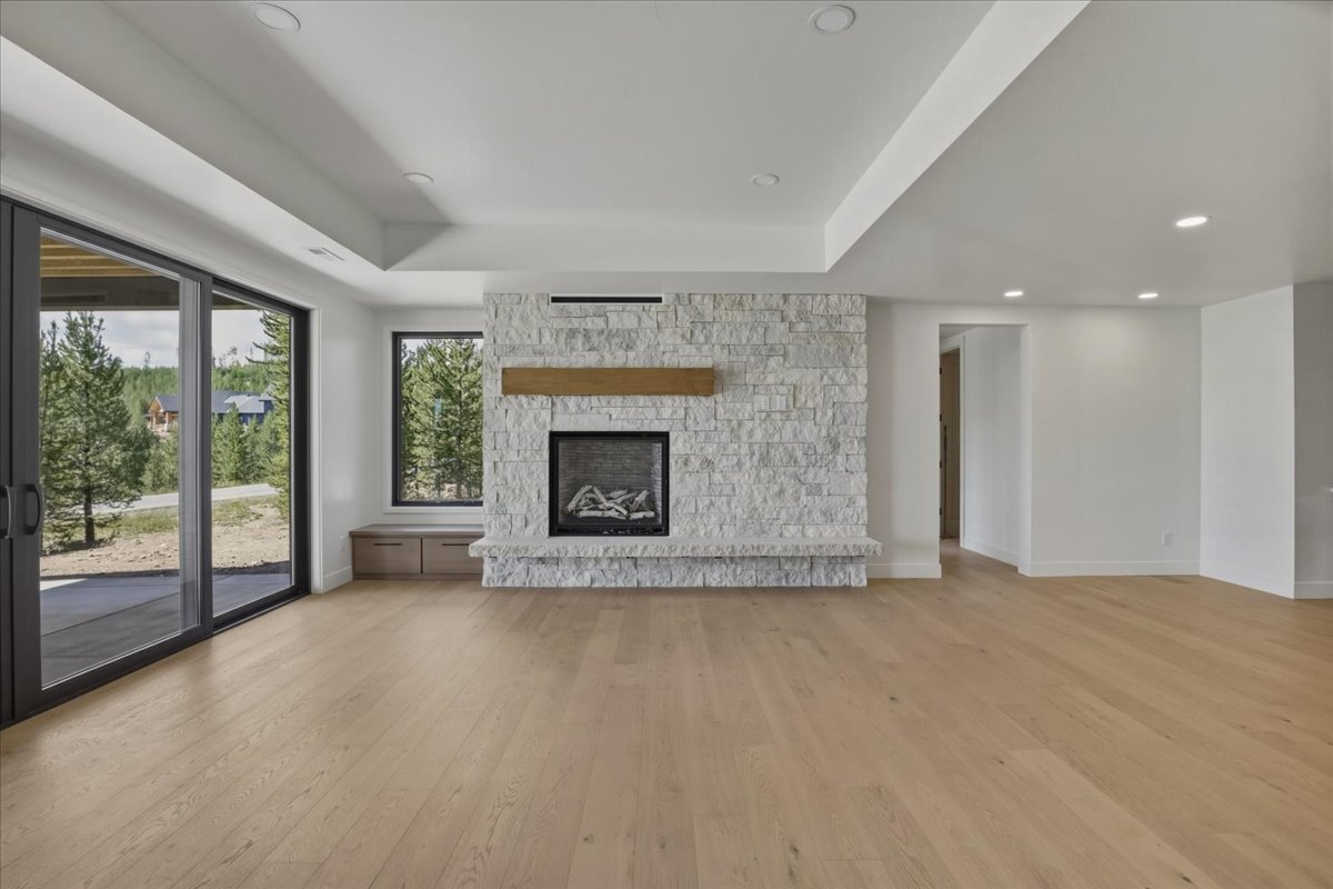 basement rec room fireplace, stone surround with stained wood mantle