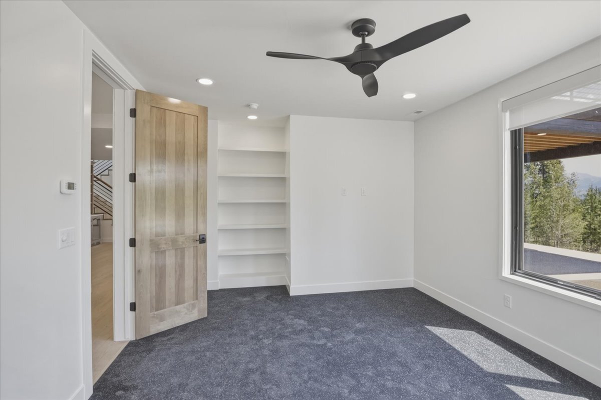 workout room with built-in shelving and rubber mat flooring