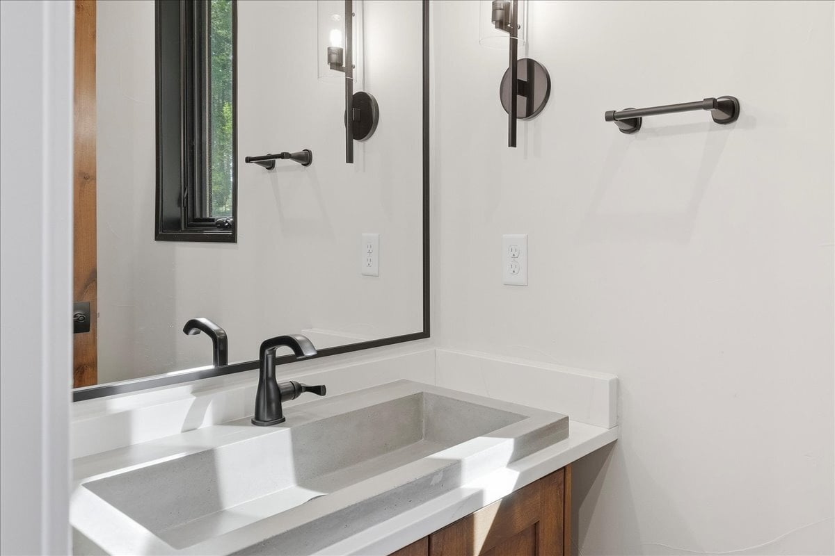 Fraser custom home - powder bath vanity with concrete raised sink