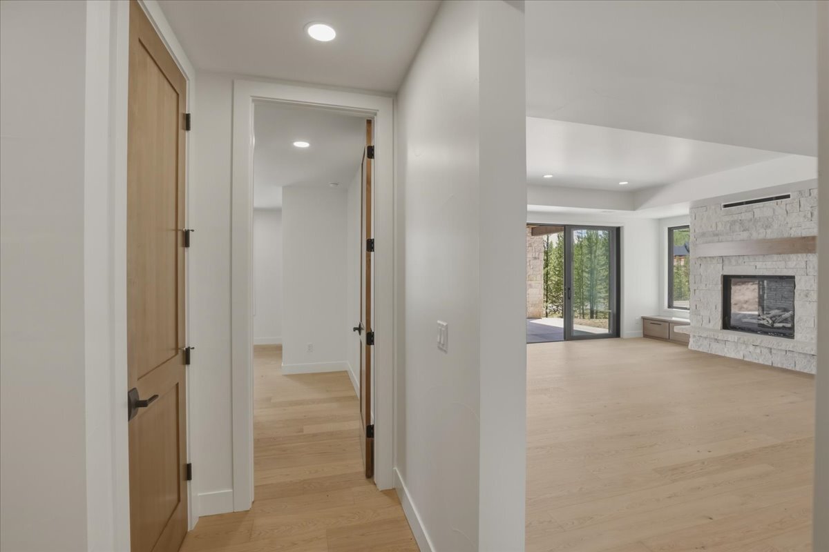 view of lower-level rec room fireplace from bedroom hallway