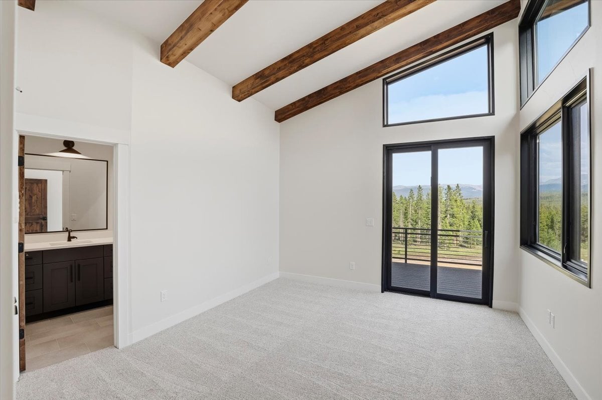 Fraser custom home - primary bedroom with beamed, vaulted ceiling