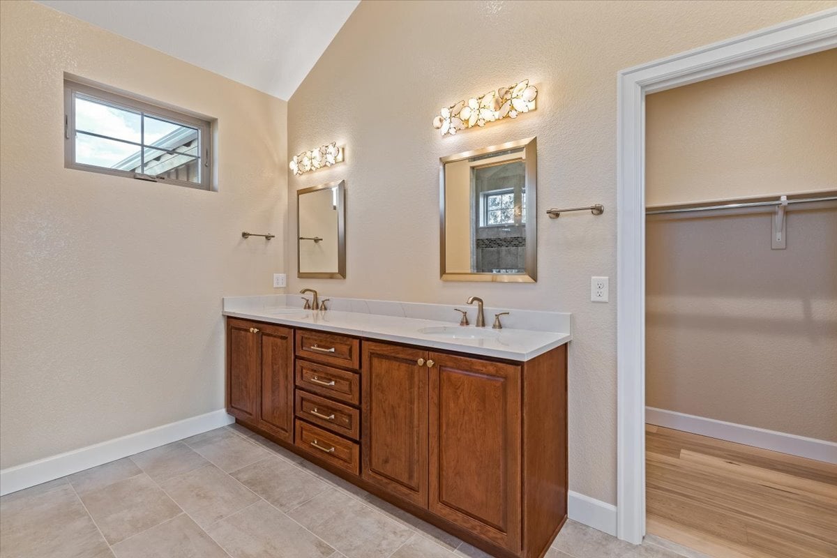 double vanity in primary bath with custom lighting