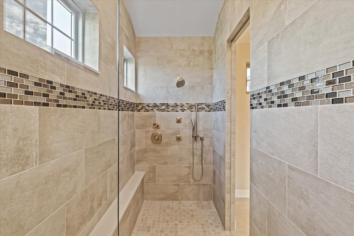 over-sized tiled walk-in shower at primary bath