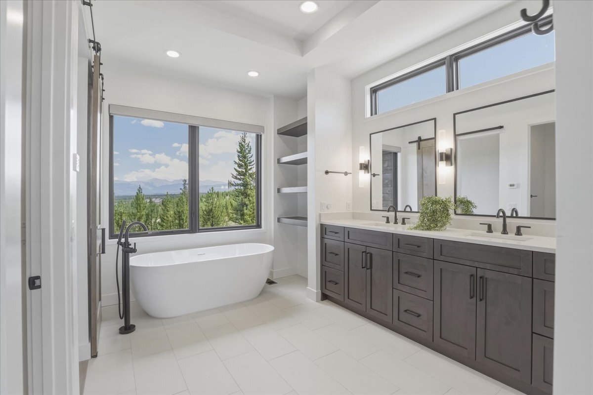 soaker tub in primary bath with mountain views