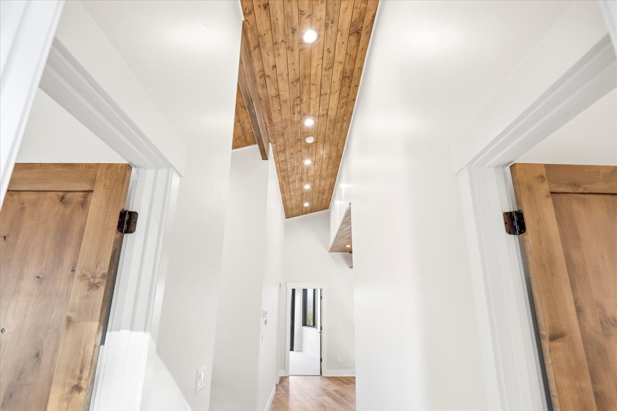Fraser custom home - detail shot showing wood paneled ceiling in upstairs hallway
