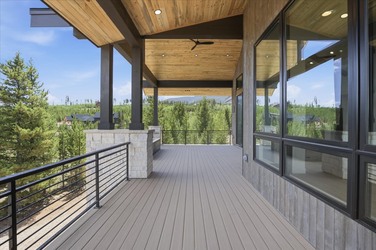 back covered deck with iron railing and tongue-and-groove ceiling