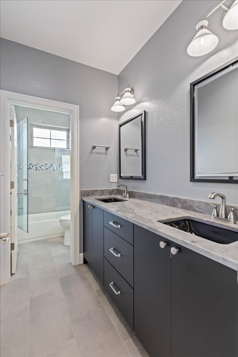 secondary bath with double vanity and separate shower area