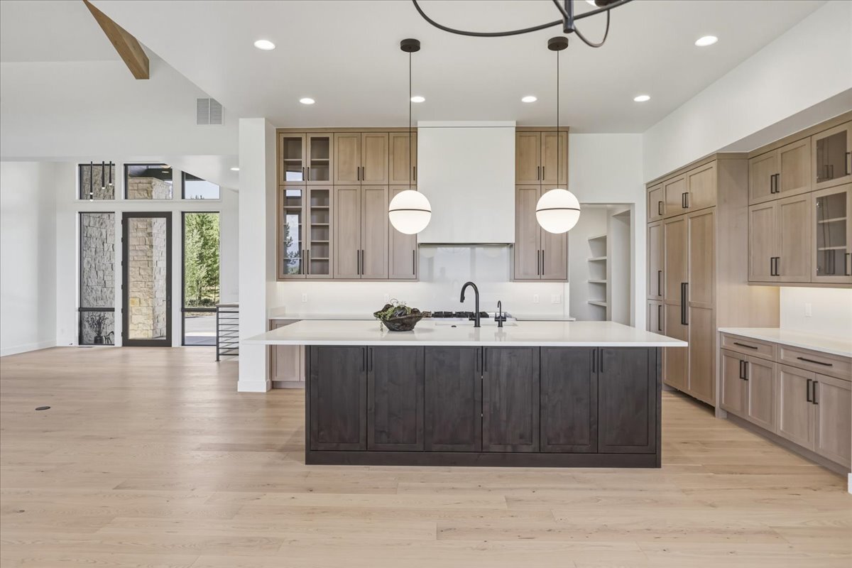 kitchen with large island and light wood cabinetry