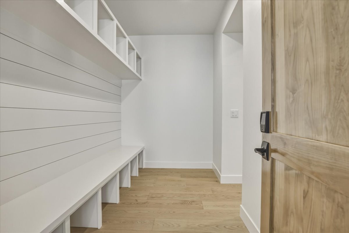 a mudroom at the owner's entrance with built-in cubbies