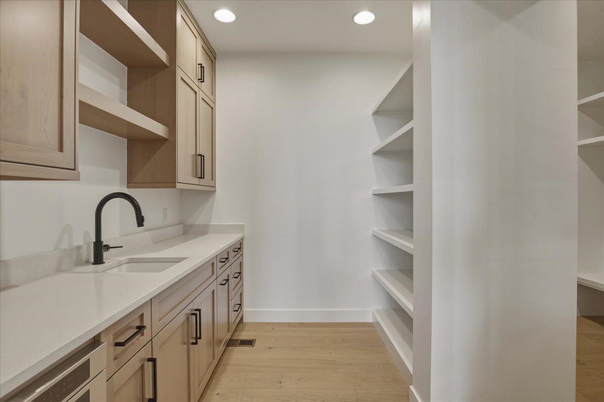 butler's pantry with prep sink, 2nd dishwasher, open shelving, and cabinets