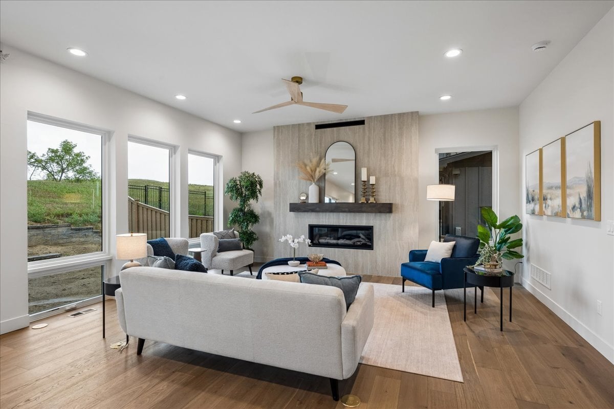 a great room with modern furnishings and large windows with unobstructed views