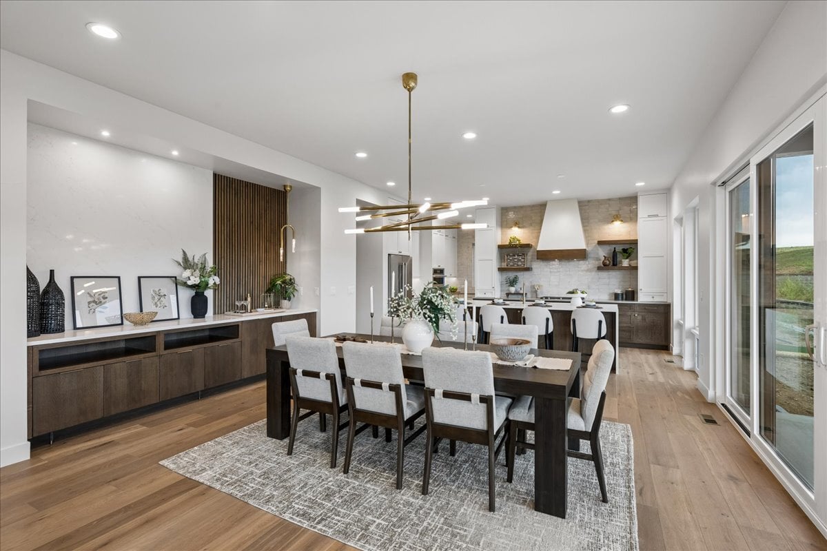 dining room featuring built-in buffet with wood paneled accent wall