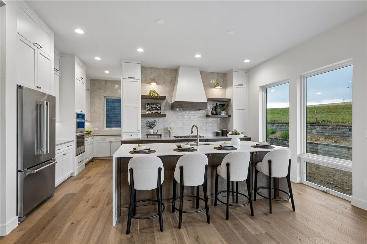 oversized kitchen island with quartz waterfall top and bar seating
