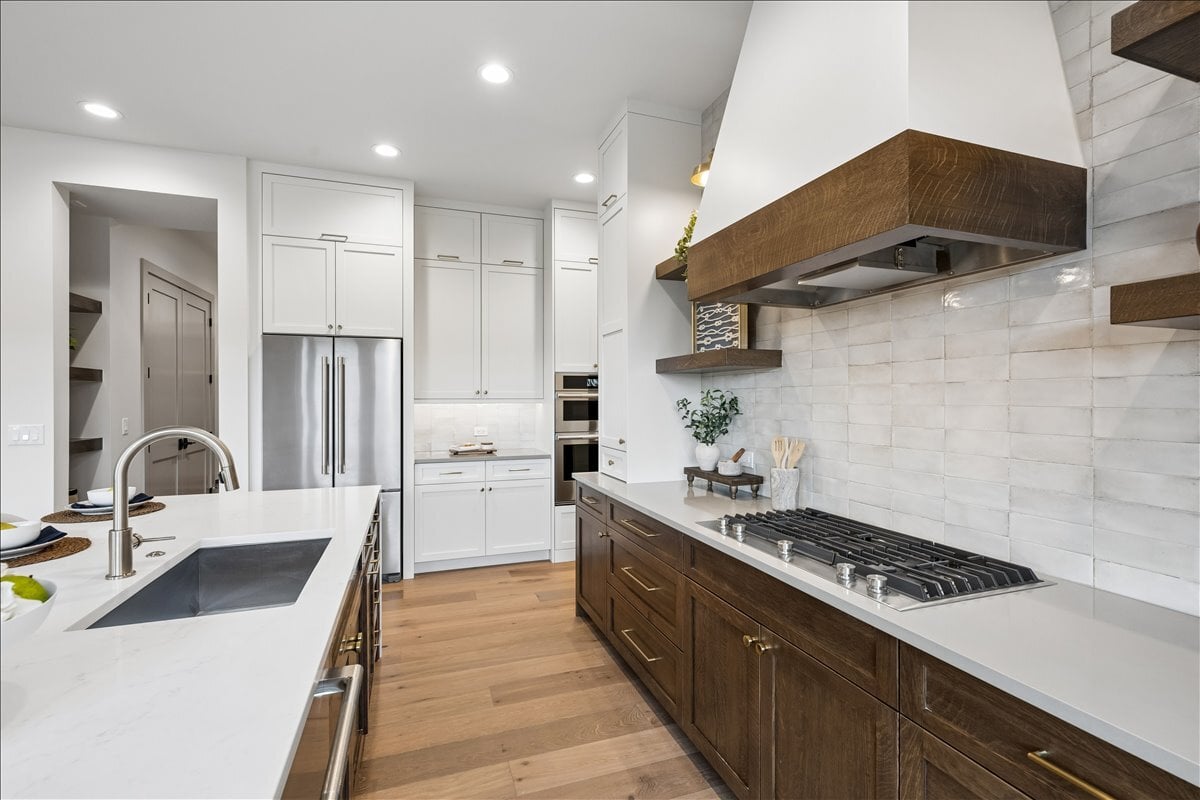 custom wood-trim kitchen range hood with drop-in cooktop