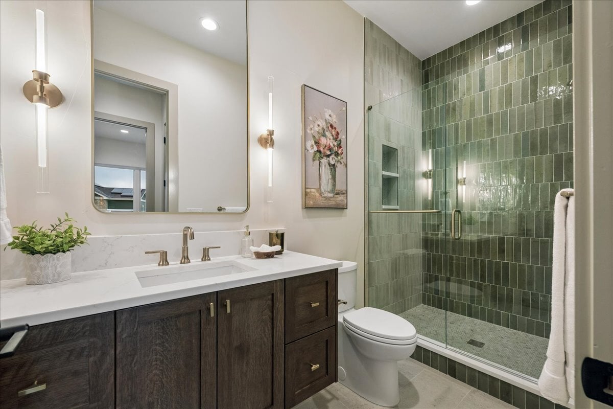 3/4 bath with custom floor-to-ceiling tile, poured shower pan, and frameless Euro-style door