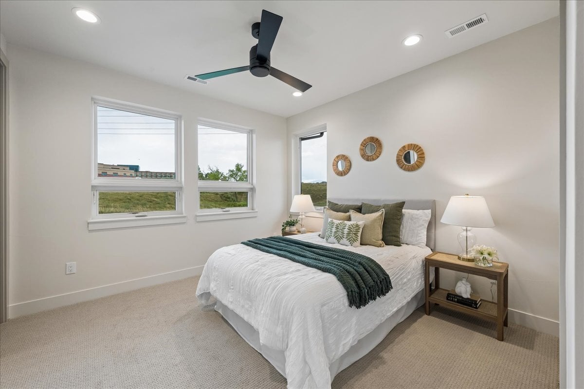 upper-level secondary bedroom with queen-sized bed and two side tables
