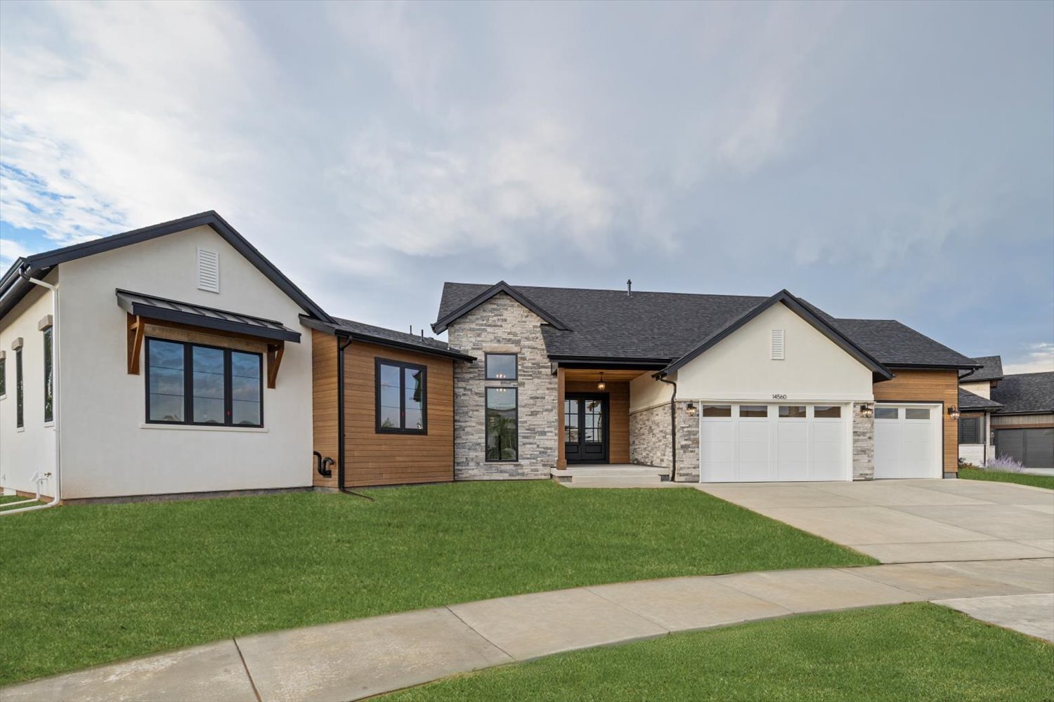 Front view of Carr Estates Ranch custom Spec home in Westminster, CO with finished landscaping and driveway