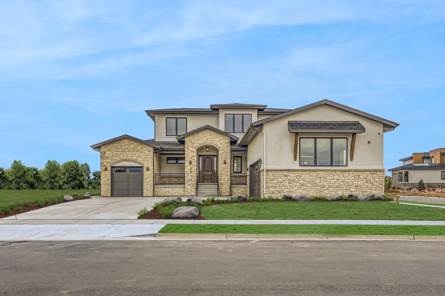 Front view of a newly built custom home in Westminster, CO, by Sheffield Homes, with elegant landscaping