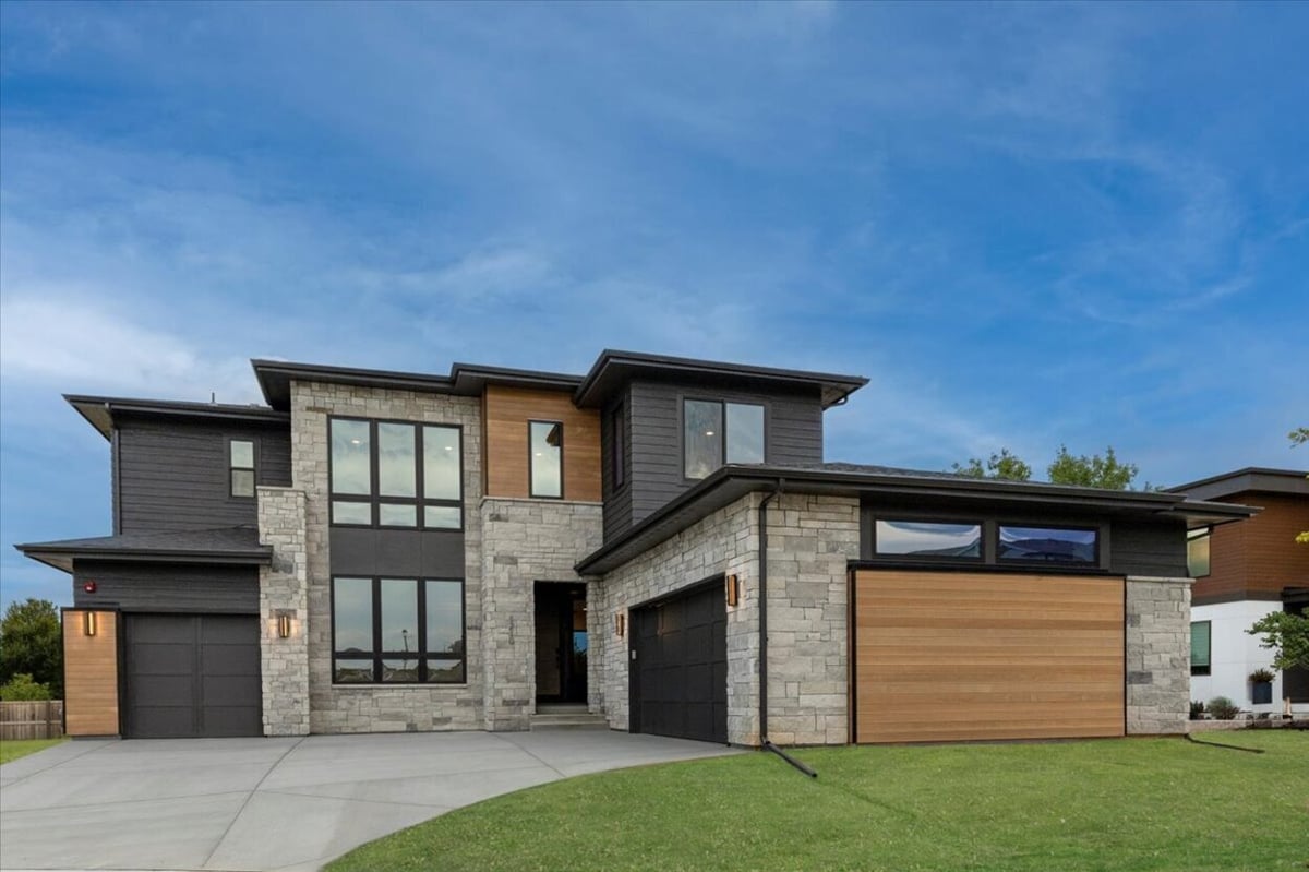 Front exterior view of luxury spec home in Denver, CO featuring stone and wood accents