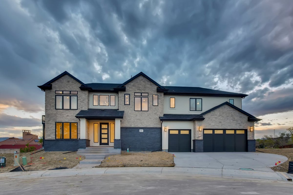 Front elevation of a custom home by Sheffield Homes in Arvada, CO, at dusk