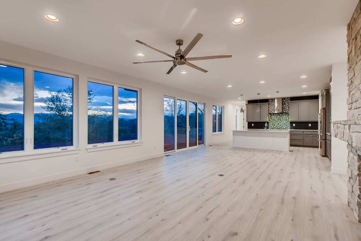 Spacious living room with large windows in a custom home by Sheffield Homes in Arvada, CO