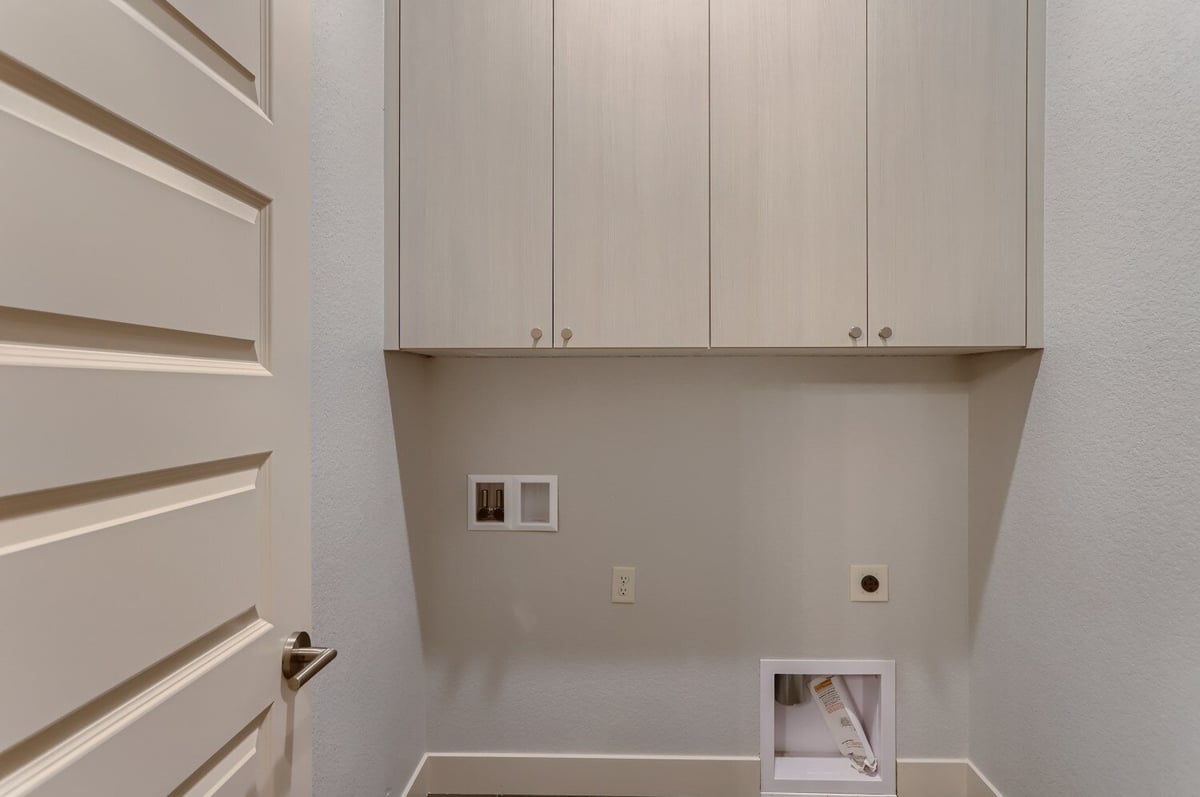 Functional laundry room with ample storage in a Sheffield Homes custom home in Arvada, CO
