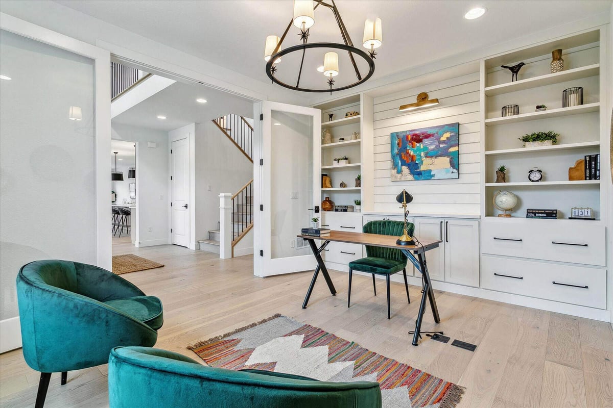 Study area with a single table and chair and two sofas in a house built by Sheffield Homes in Arvada, CO