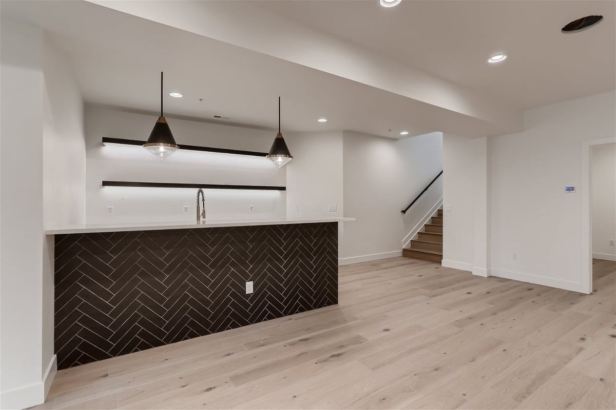 Corner bar area in a living room with elegant lighting in a custom home by Sheffield Homes in Evergreen, CO
