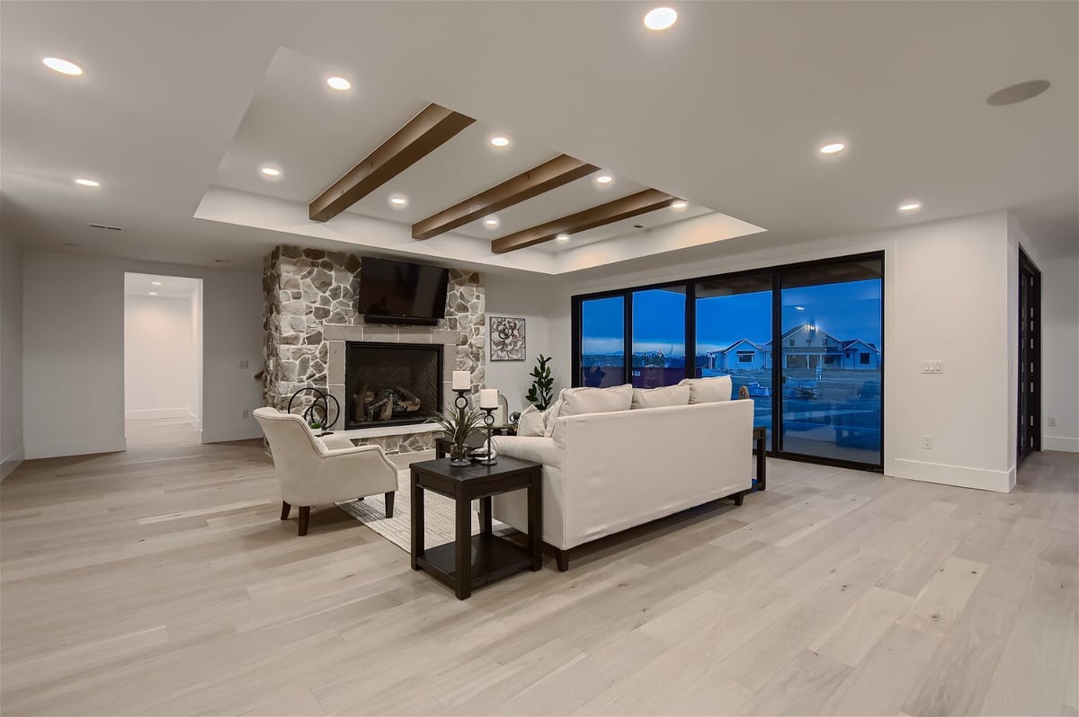 Premium family room with modern furniture and elegant lighting fixtures in a custom home by Sheffield Homes in Franktown, CO