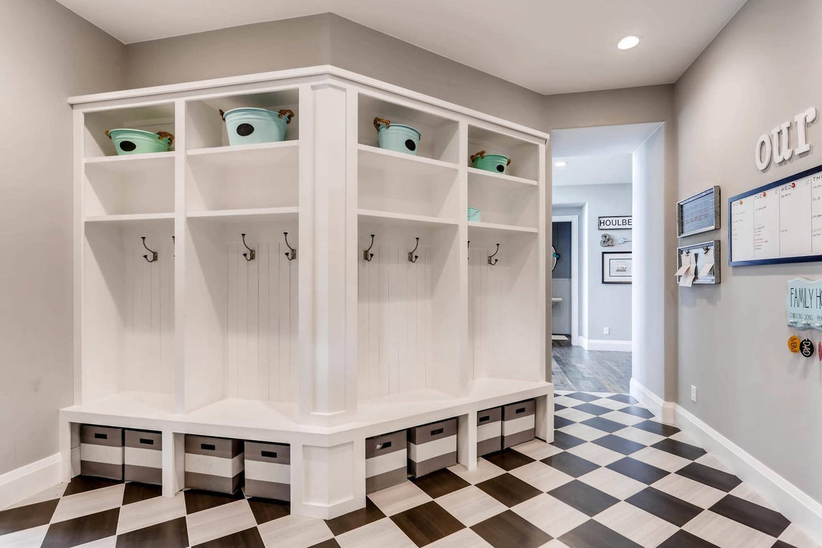 Owner_s entrance with a checked floor design, a quick mudroom, and a pathway leading inside by Sheffield Homes in Parker, CO