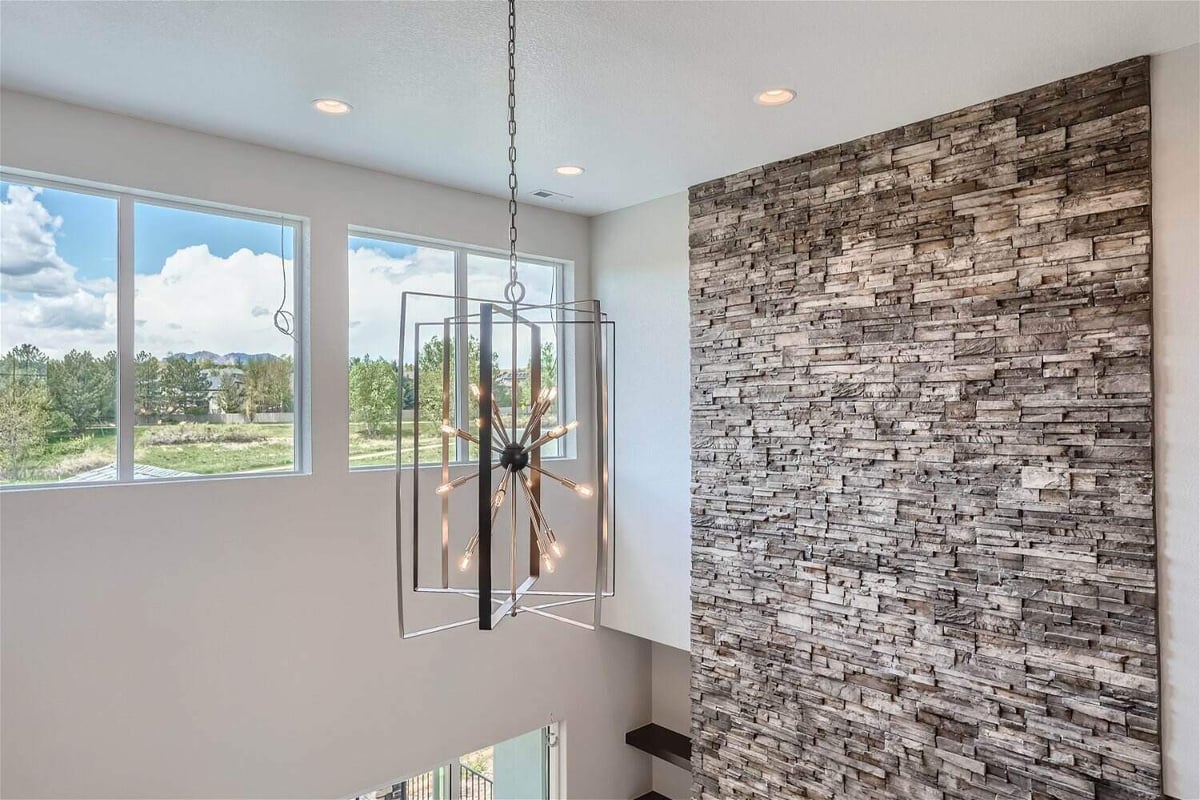 Detailed view of a pendant chandelier in the main hall from the second floor in a Sheffield Homes home in Superior, CO