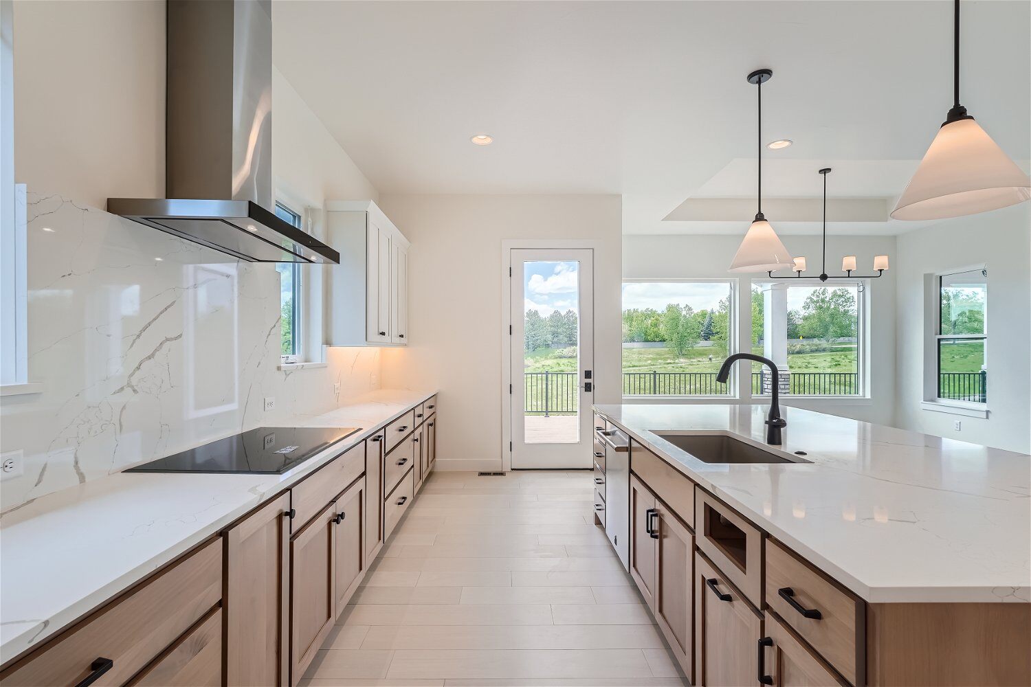 Open kitchen island and main counter with spacious cabinetry in a custom home by Sheffield Homes in Superior, CO