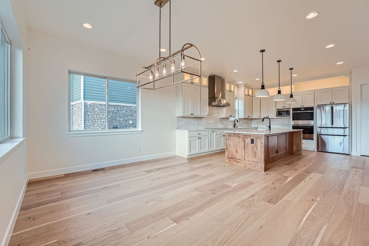 Dining area in a custom Denver home by Sheffield Homes, offering scenic views through large windows