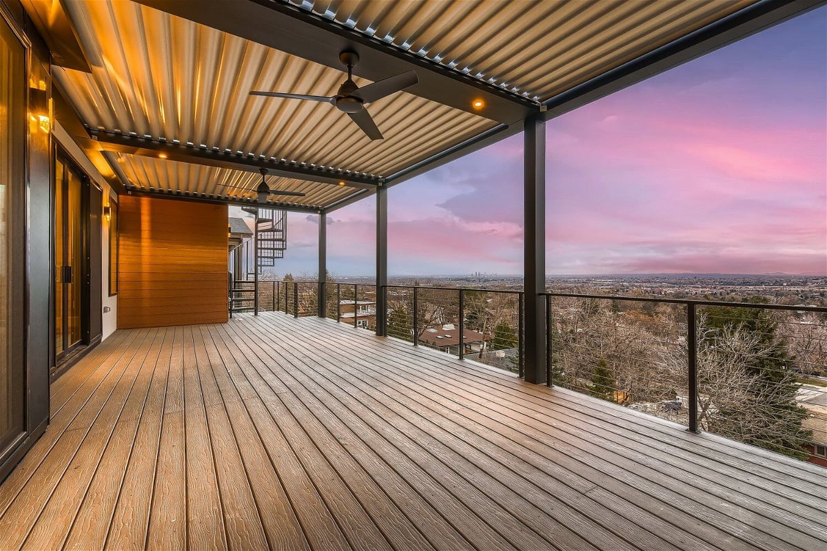 Covered deck with wood flooring and city views by Sheffield Homes in Denver, CO