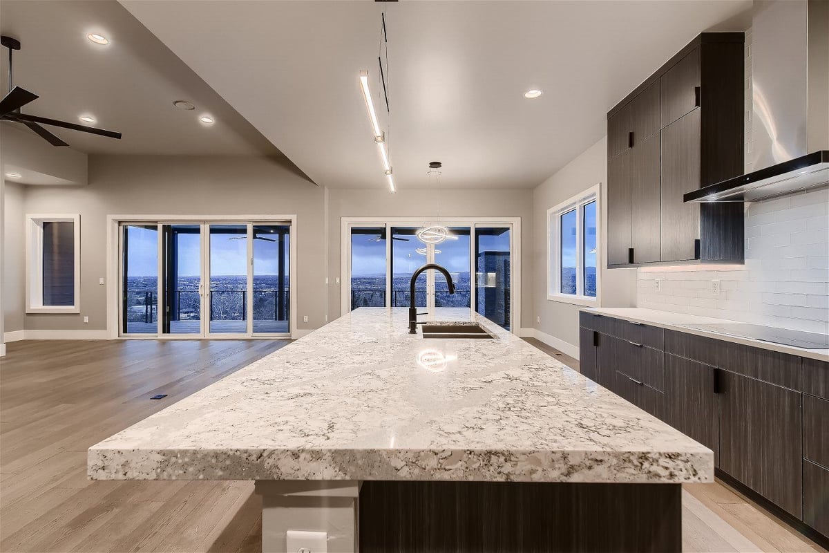 Modern kitchen with a large marble island in a Sheffield Homes custom-built home in Denver, CO