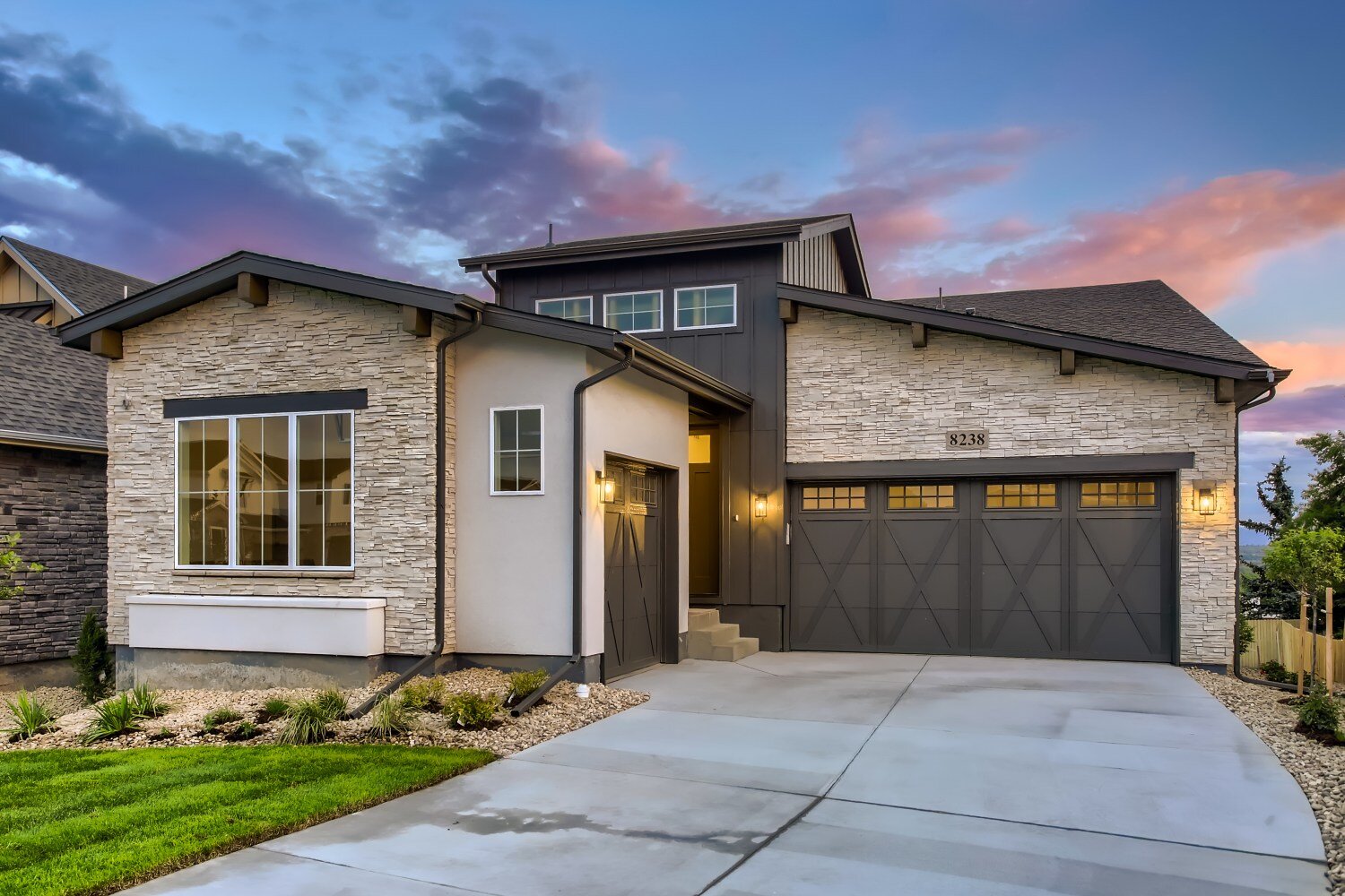 Front exterior of custom home featuring light stone and black trim in Denver, CO by Sheffield Homes