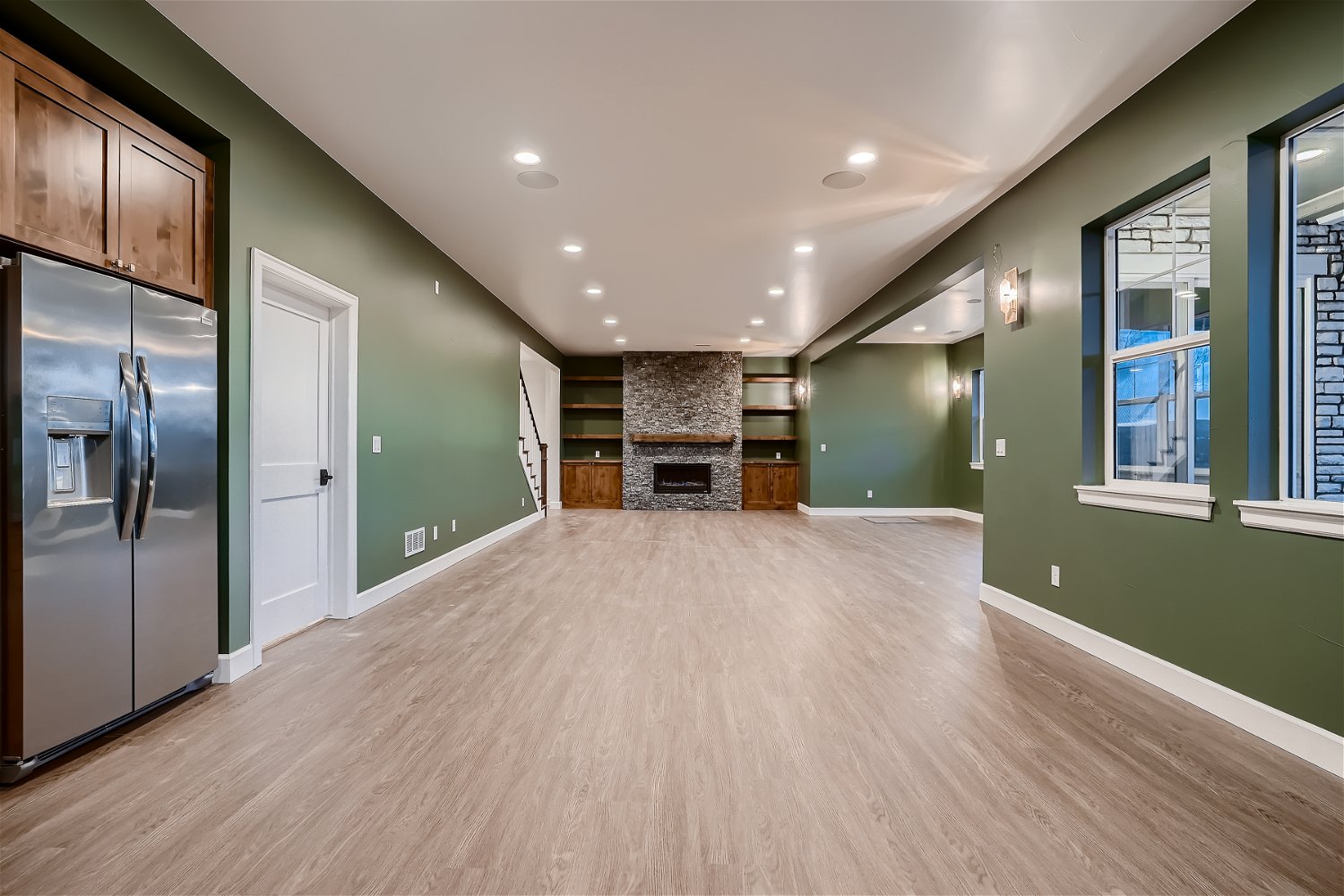 Finished basement by Sheffield Homes with fireplace and built-ins